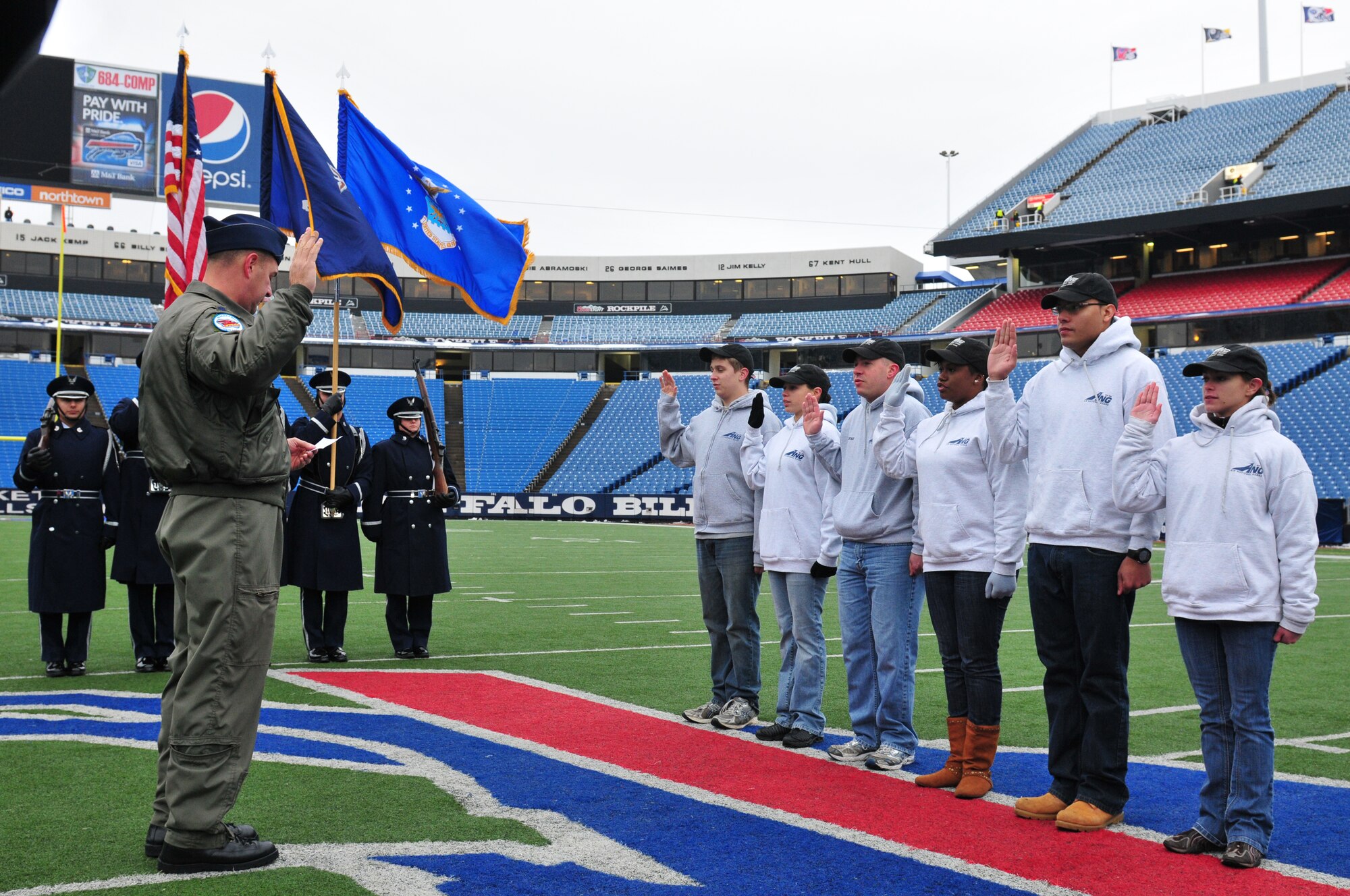 During a Buffalo Bills pregame ceremony held Sunday morning, six of the newest members of the New York Air National Guard's 107th Airlift Wing took the Oath of Enlistment. The ceremony was played during halftime on the Jumbotron for the fans to see.  Lt. Col. James Hoch swears in from left to right Airmen 1st class Daniel Tremblett, Cara Sturdivant, Keith McArthur, Christina Swanson, Joshua Velez and Joanna Vail. (U.S. Air Force photo/Tech. Sgt. Justin Huett)  