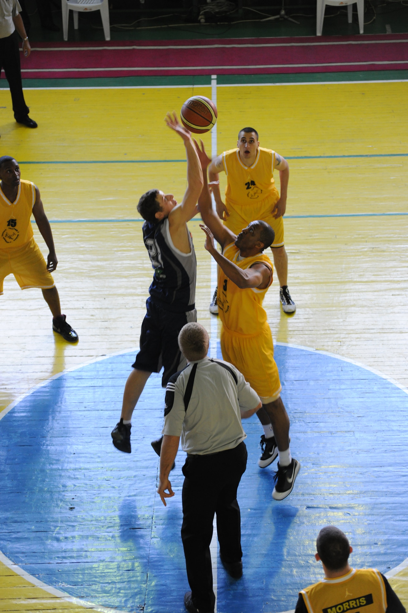 BISHKEK, Kyrgyzstan - Tech Sgt. Jamal Berry, 728th Aircraft Maintenance Squadron, reaches for the ball during tip off against the Kyrgyz National University during a basketball game at the Kyrgyz Sports Palace in Bishkek, Nov. 27.  The Kyrgyz National Men's Team defeated the Transit Center team with a final score of 60-42.  (U.S. Air Force photo/Staff Sgt. Nathan Bevier)
