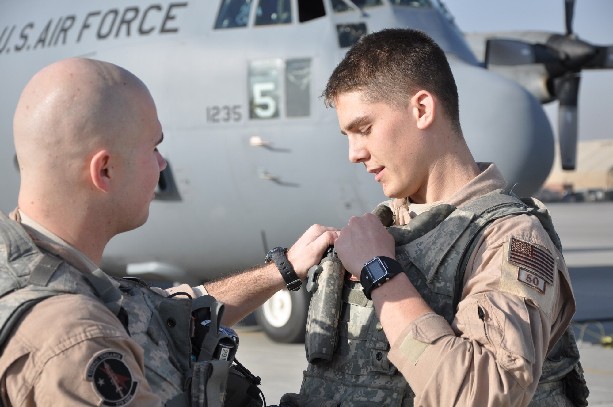 Senior Airman Kailan Smith (left), a 379th Air Expeditionary Wing fly away security team leader, helps his wingman, Senior Airman Jordan Gunterman, to adjust his equipment while at Bagram Airfield, Afghanistan.  (U.S. Air Force Photo/Capt. Erick Saks)