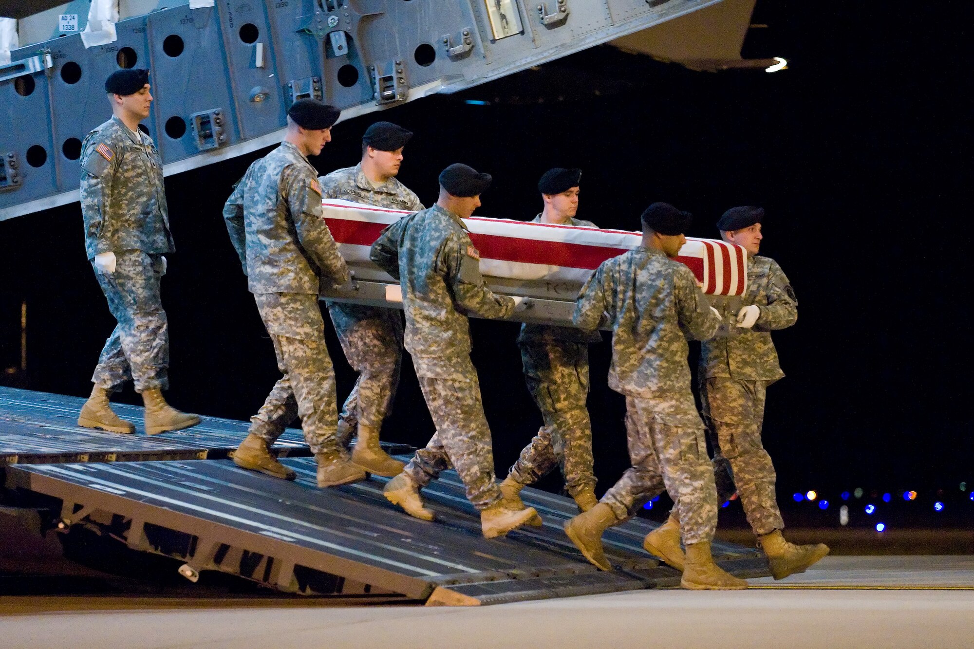A U.S. Army carry team transfers the remains of Army Pvt. Devon J. Harris, of Mesquite, Texas, at Dover Air Force Base, Del., Nov. 28, 2010.  Pvt. Harris was assigned to the Brigade Special Troops Battalion, 10th Mountain Division, Fort Polk, La. (U.S. Air Force photo/Roland Balik)