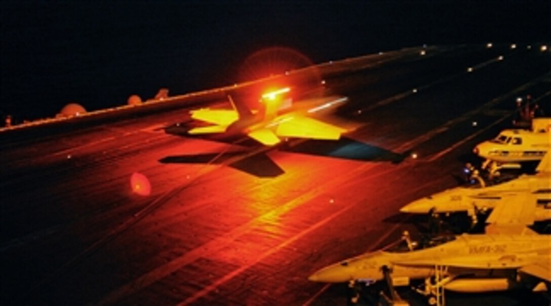 An F/A-18F Super Hornet assigned to Strike Fighter Squadron 32 catches the arresting wire aboard the aircraft carrier USS Harry S. Truman (CVN 75) during night flight operations in the Arabian Sea on Nov. 22, 2010.  Strike Fighter Squadron 32 is deployed with the Harry S. Truman Carrier Strike Group supporting maritime security operations and theater security cooperation efforts in the U.S. 5th Fleet area of responsibility.  
