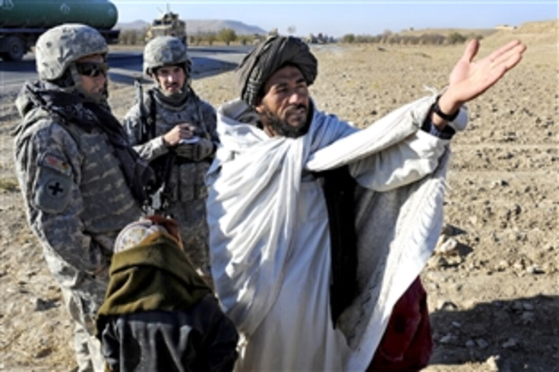 U.S. Army 1st Lt. Raymond Gobberg, center, talks with a village elder during a canal site survey near Highway 1, Zabul Province, Afghanistan, Nov. 27, 2010. Gobberg and the elder discussed the problems facing his village as well as how he receives information about the local government. Gobberg is assigned to the Provincial Reconstruction Team Zabul.