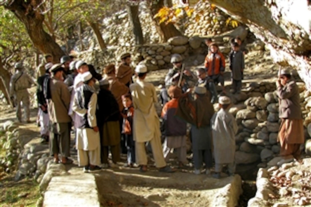 Local malets meet with civil engineers and a U.S. Agency for International Development representative from the Kapisa Provincial Reconstruction Team in Surobi, Kapisa province, 
Afghanistan, to discuss civil works projectsd, Nov. 26, 2010.