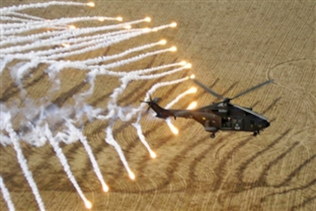 A Cougar AS3/32 helicopter tests its flares during a tactical exercise over Badghis, in western Afghanistan, Nov. 28, 2010.