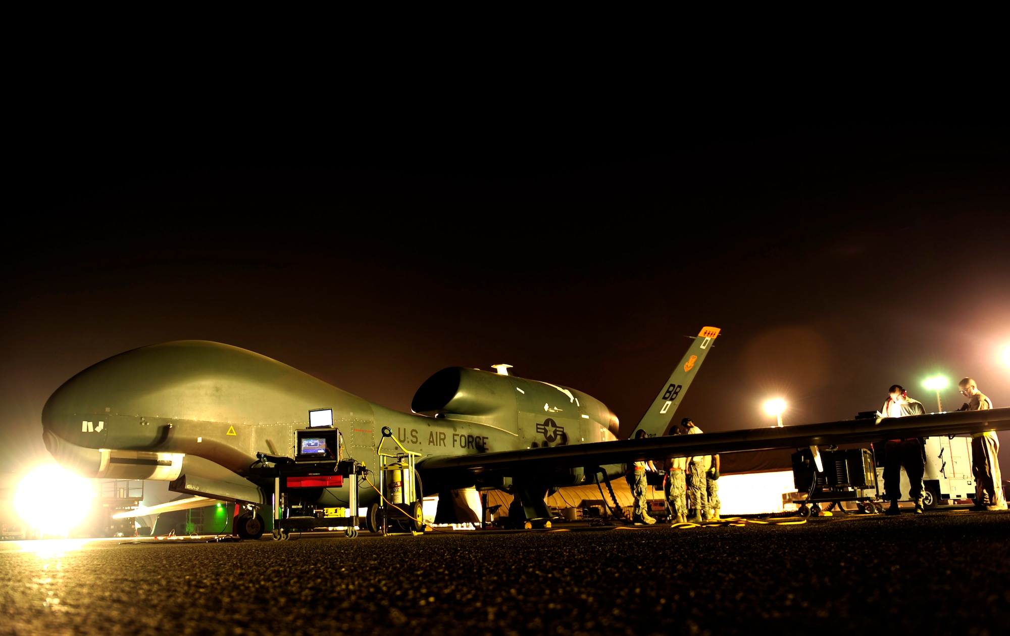 An RQ-4 Global Hawk gets prepared for a mission while deployed Nov. 23, 2010, at an air base in Southwest Asia. The RQ-4 and the Airmen are assigned to the 380th Expeditionary Operations Group. (U.S. Air Force photo/Staff Sgt. Andy M. Kin)