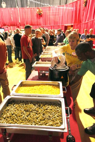 Marines and sailors from Combat Logistics Regiment 2, 2nd Marine Logistics Group, along with friends and family enjoy food and refreshments during a family Christmas party at the Goettge Memorial Field House aboard Camp Lejeune, Nov. 30, 2010. During the party approximately 300 personnel with the regiment, along with their family and friends, got their face painted, played video games, enjoyed food and refreshments, and won prizes. (U.S. Marine Corps photo by Pfc. Franklin E. Mercado)
