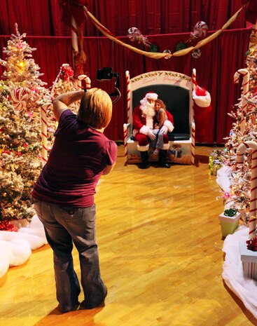Children were given the opportunity to take pictures with Santa Claus during a Combat Logistics Regiment 2, 2nd Marine Logistics Group, family Christmas party at the Goettge Memorial Field House aboard Camp Lejeune, Nov. 30, 2010. During the party approximately 300 personnel with the regiment, along with their family and friends, got their face painted, played video games, enjoyed food and refreshments, and won prizes. (U.S. Marine Corps photo by Pfc. Franklin E. Mercado)