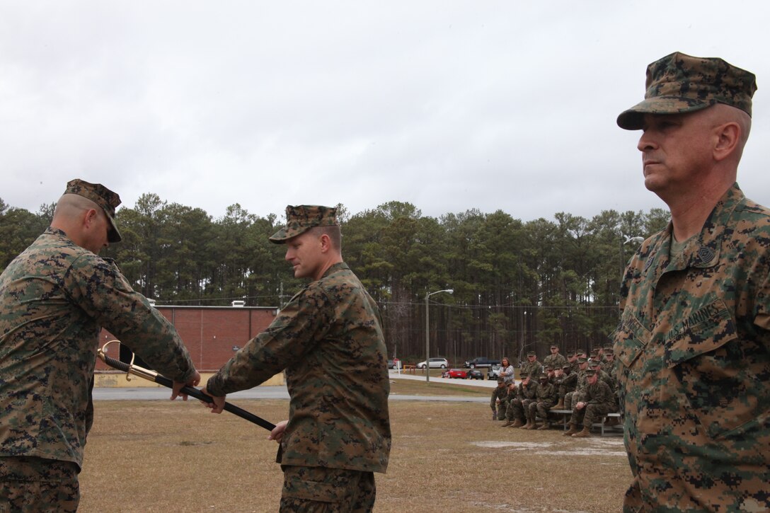 Sgt. Maj. William R. Sweet, right, the former sergeant major of Marine Air Control Squadron 2, stands by as Sgt. Maj. Alex M. Dobson, left, receives Marine Air Control Squadon 2’s squadron noncommissioned officer sword from the squadron’s commanding officer, Lt. Col. Chris S. Richie, middle, at the MACS-2 parade field Dec. 1. “I know Sgt. Maj. Dobson will lead the Marines in a very efficient manner,” said Sweet.