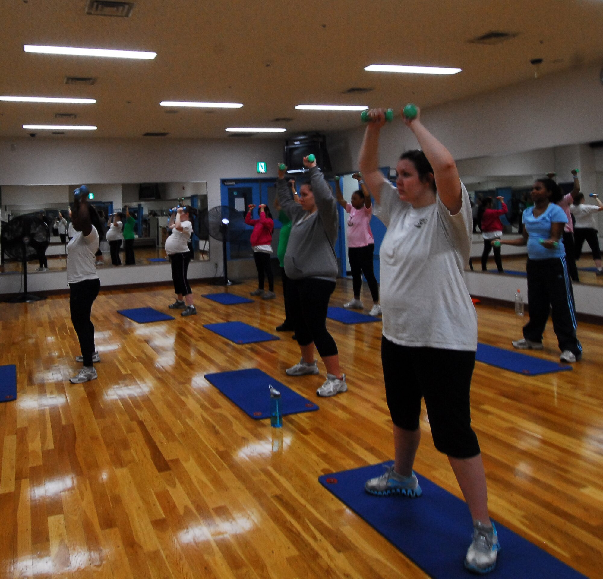 YOKOTA AIR BASE, Japan -- Future moms lift weights in the prenatal class taught by Staff Sgt. Treshawna Gwendo, diet therapist at the 374th Aerospace Medicine Squadron. 'Fit Moms' is a prenatal class offered at Yokota's Health and Wellness Center, Tuesdays and Thursdays from 3:30 p.m. to 4:30 p.m. (U.S. Air Force photo/Airman 1st Class Lynsie Nichols)