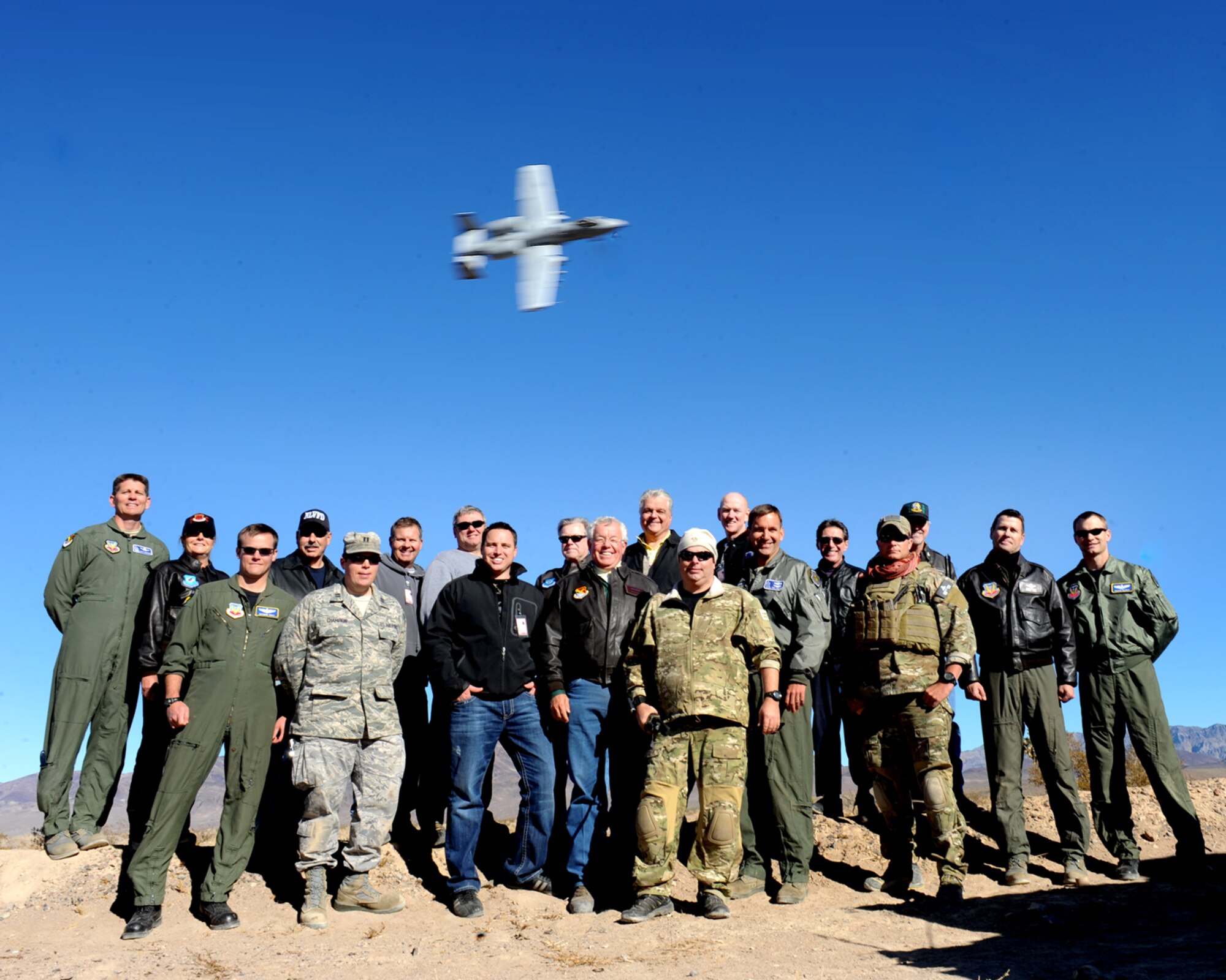 NELLIS AIR FORCE BASE, Nev. – Members of the Nellis Support Team and local elected officials pose with Nellis leadership for a group photo on the Nevada Test and Training Range Nov. 22. The Nellis Support Team and their guests visited the Nevada Test and Training Range so they could see some of the daily training Nellis conducts on the range, which varies from the GCTS to target practice for our A-10s. (U.S. Air Force photo by Jamie Nicley)