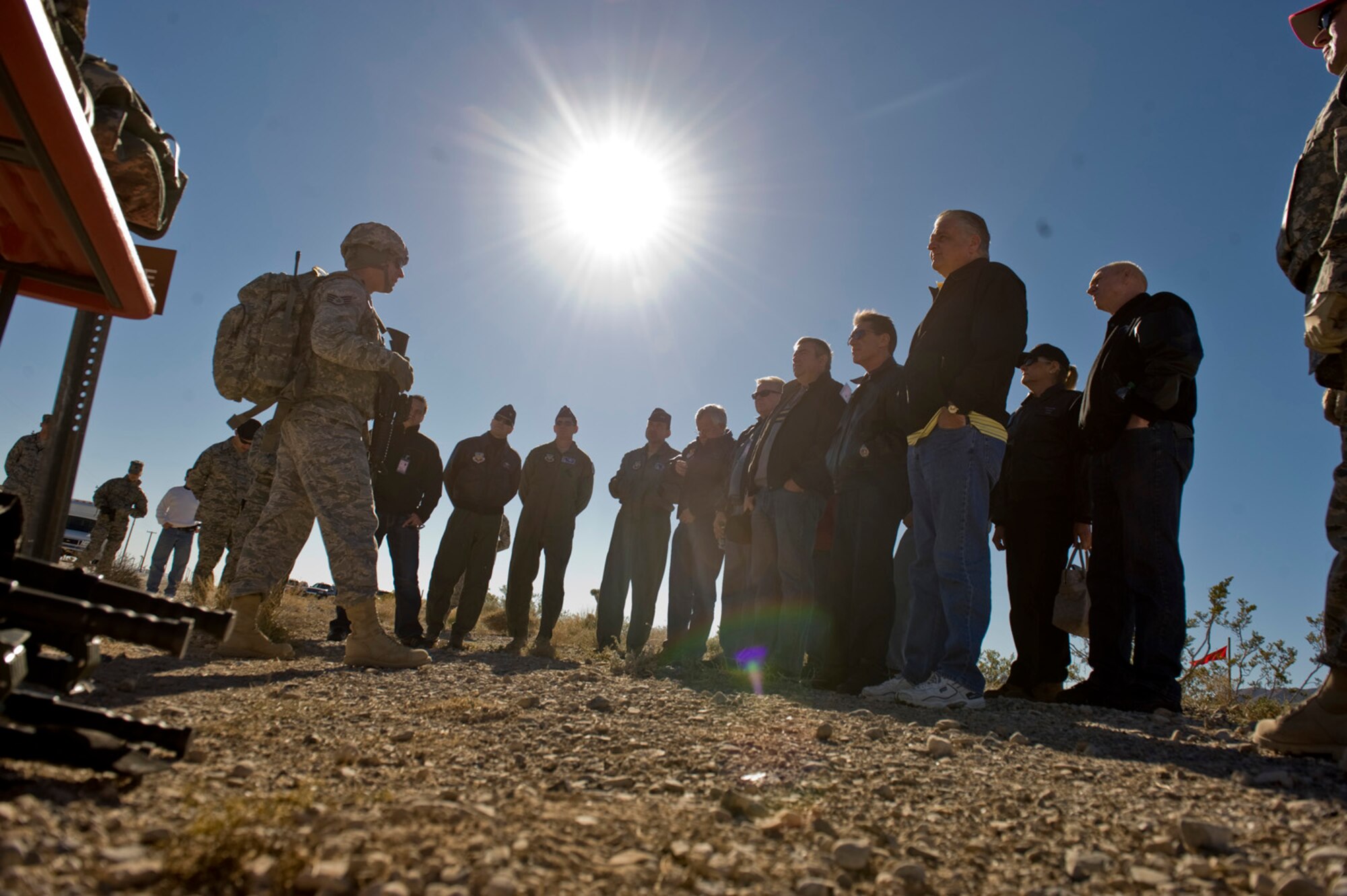 NELLIS AIR FORCE BASE, Nev. – Staff Sgt. Christopher Lenz, 99th Ground Combat Training Squadron instructor, gives a brief on procedures during a Nellis Support Team tour of the Nevada Test and Training Range. The 98th RANW provides command and control of the Nevada Test and Training Range. The commander coordinates, prioritizes and is the approval authority for activities involving other governmental agencies, departments and commercial activities on the NTTR. The 98th RANW integrates and provides support for test and training programs that have a direct effect on the war-fighting capabilities of the combat air forces. (U.S. Air Force photo by Airman 1st class Jamie Nicley)