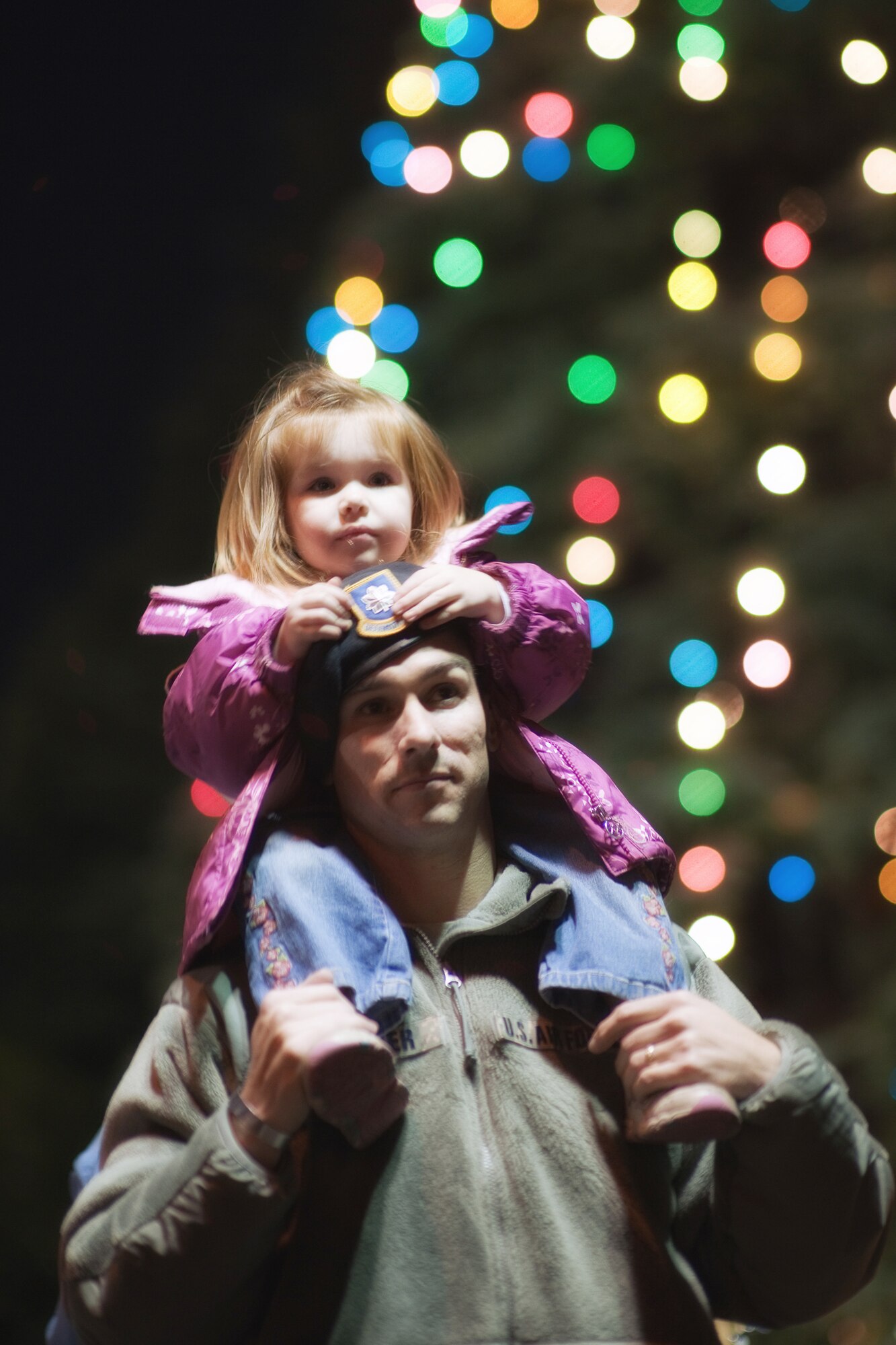 YOKOTA AIR BASE, Japan -- The Yokota Christmas Tree Lighting Ceremony was held Nov.30 at the Traditional Chapel. Lt. Col. Kevin Walker, 374th Security Forces Squadron commander, participates in the ceremony with his daughter, Addison.  (U.S. Air Force photo/Osakabe Yasuo)