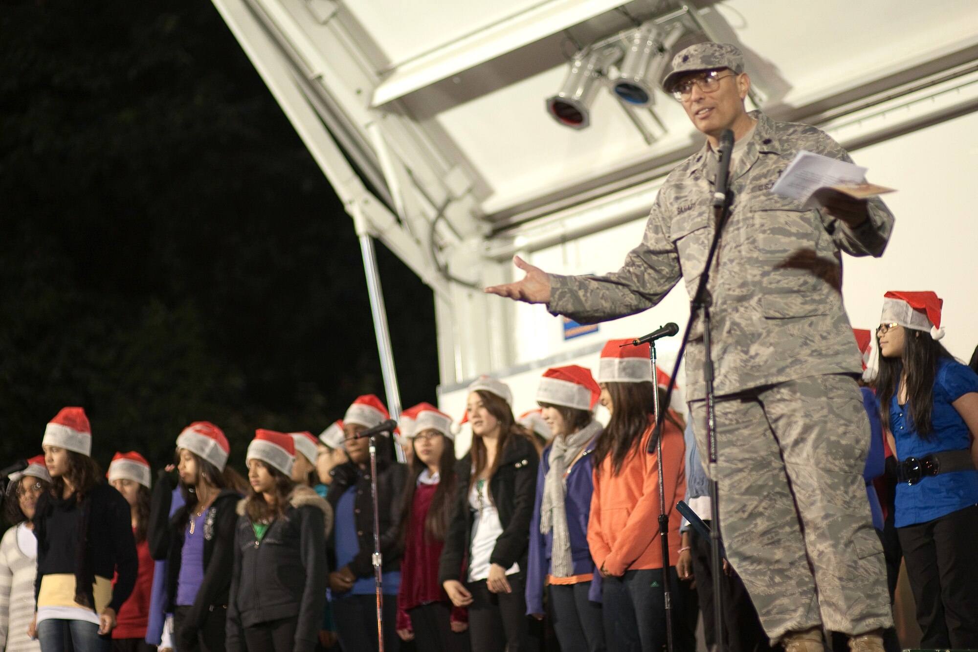 YOKOTA AIR BASE, Japan -- 374th Airlift Wing Chaplain (Lt.Col.) Mark Sahady and the Yokota Middle School Choir kick off the the base Christmas Tree Lighting Ceremony here, Noc. 30. (U.S. Air Force photo/Osakabe Yasuo)