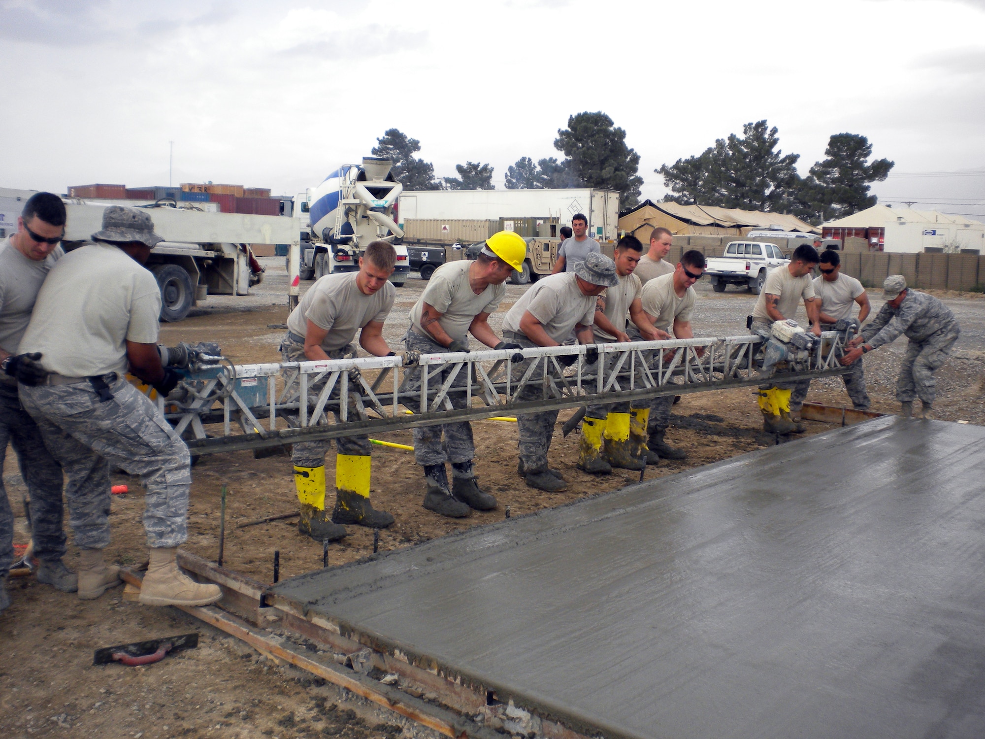 Reservists from Hill’s 419th Civil Engineer Squadron and other Airmen remove a power screed from freshly poured cement where a tent will be erected. (Courtesy photo)