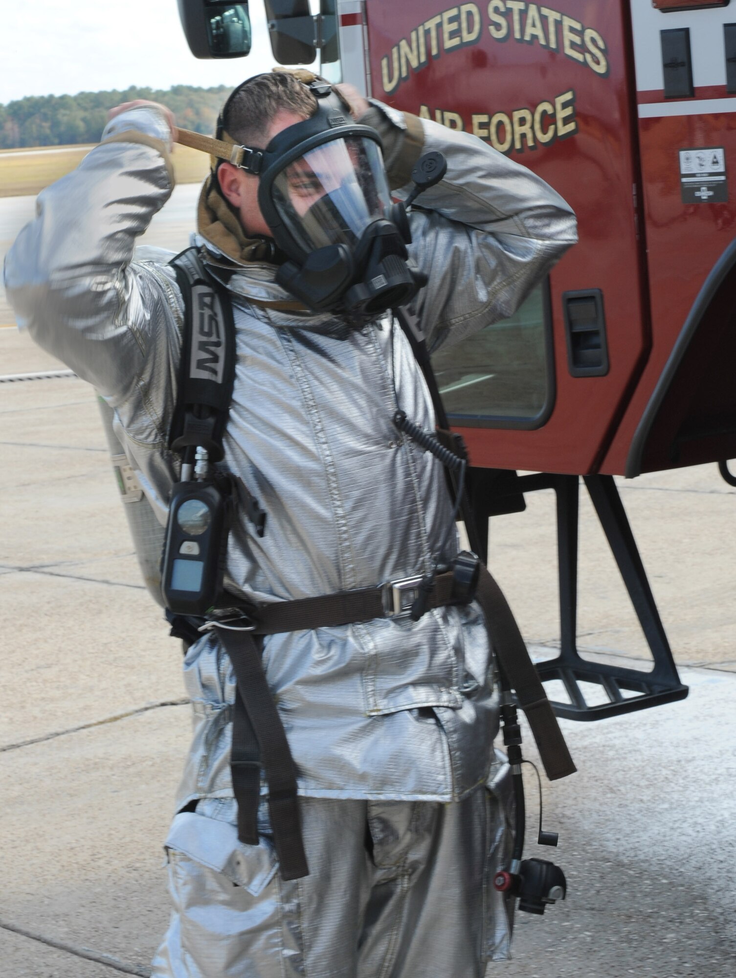MOODY AIR FORCE BASE, Ga. -- Airman 1st Class Gary Simmons Jr., 23rd Civil Engineer Squadron firefighter, dons a self contained breathing apparatus mask Nov. 22. The 23rd CES fire department was helpful in the squadron winning the 2010 Society of American Military Engineers Curtin Award for best small unit in Air Combat Command. They responded to four fires, two aircraft crashes and five hazardous material emergencies, which resulted in zero fatalities. (U.S. Air Force photo/Airman 1st Class Douglas Ellis)(RELEASED)
