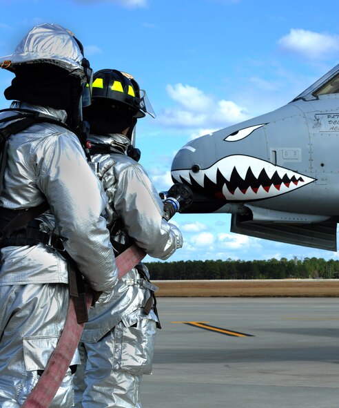 MOODY AIR FORCE BASE, Ga. -- Firefighters from the 23rd Civil Engineer Squadron, deploy a handline during a drill Nov. 22. The handline is another term for a fire hose. The 23rd CES recently received the 2010 Society of American Military Engineers Curtin Award for best small unit in Air Combat Command. The squadron was honored this year during an awards banquet at Langley Air Force Base, Va. (U.S. Air Force photo/Airman 1st Class Douglas Ellis)(RELEASED)