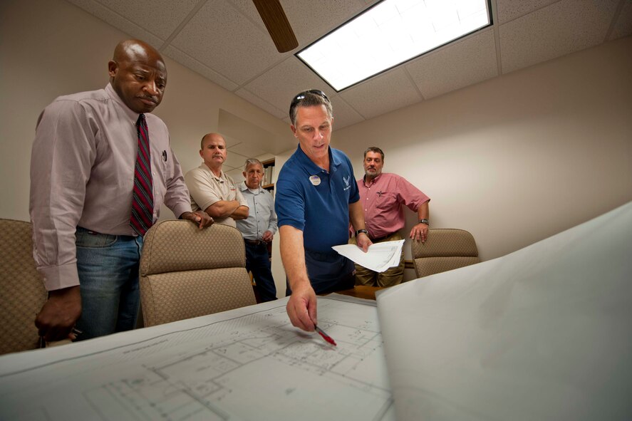 MOODY AIR FORCE BASE, Ga. -- Kevin Davalos (center), 23rd Force Support Squadron fitness center director, discusses plans on fitness center additions with the 23rd Civil Engineer Squadron programs flight Nov. 24. The programs flight was instrumental in opening Moody Air Force Base's first Gold Leadership Energy Environmental Design (LEED) dormitory earlier this year, which allowed unaccompanied Airmen to live in apartment style quarters. (U.S. Air Force photo/Senior Airman Jamal D. Sutter)