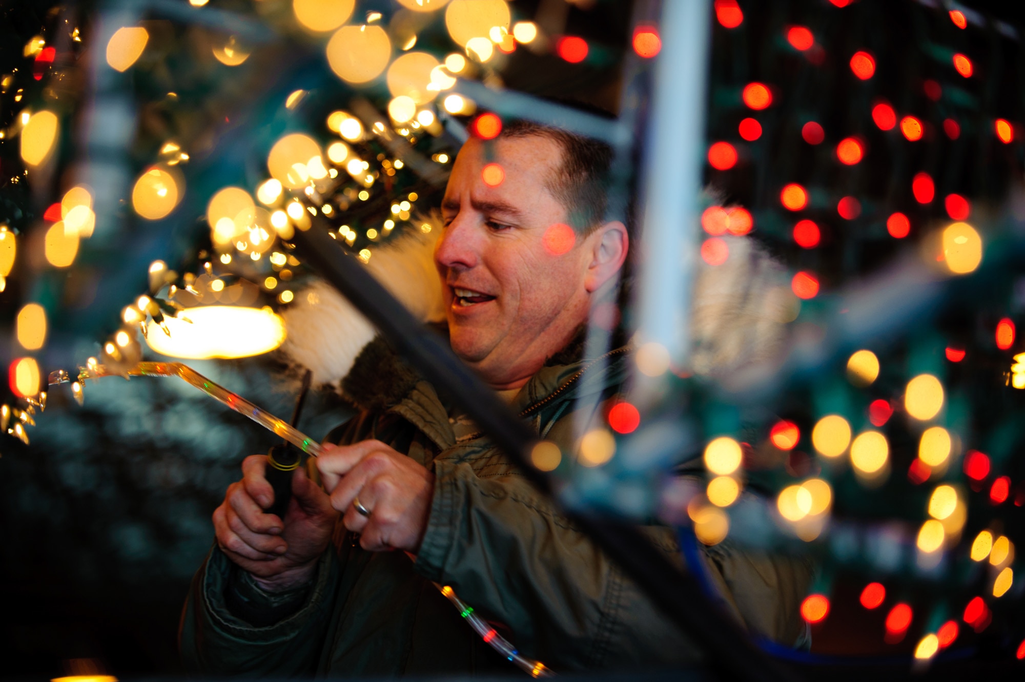ELLWORTH AIR FORCE BASE, S.D. – Master Sgt. Mike Brathole attaches more lights to the Ellsworth AFB float Nov. 23. He has worked on the float for the past three years and oversaw the float’s complete rebuild to ensure it was ready for the annual Festival of Lights parade in Rapid City, S.D. Sergeant Brathole is the 28th Bomb Wing career assistance advisor. (U.S. Air Force photo/Tech. Sgt. Nathan Gallahan)