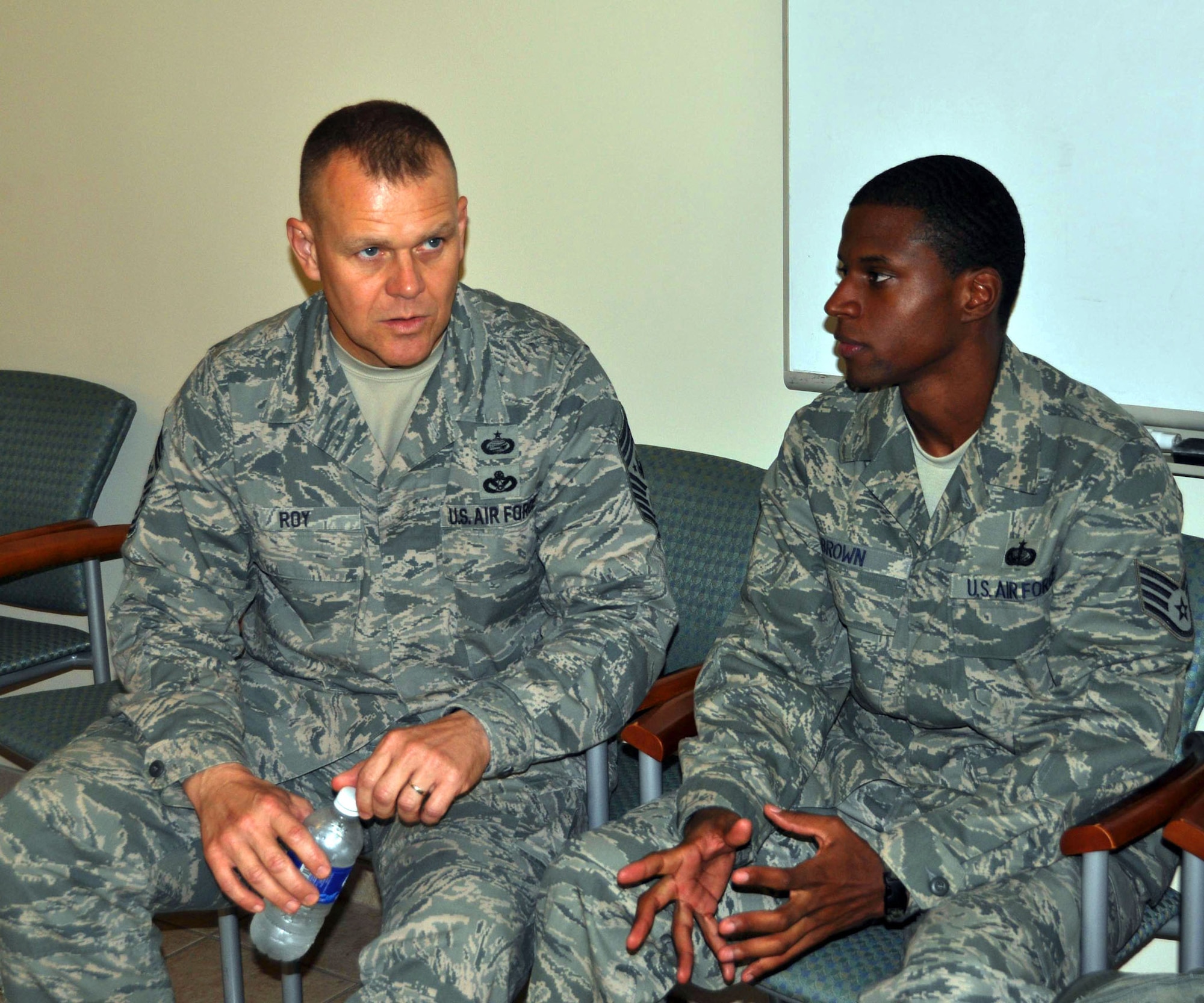 TRAVIS AIR FORCE BASE, Calif. -- Staff Sgt. Brandon Brown, a reservist with the 349th Memorial Affairs Squadron, talks with Chief Master Sgt. of the Air Force, James Roy. Sergeant Brown is deployed to the Air Force Mortuary Affairs Operations Center at Dover Air Force Base, Del., and the Chief stopped in for a morale visit with the team there. Sergeant Brown is assigned to the carry team for the Port Mortuary. (U.S. Air Force photo/Staff Sgt. Jamie George)