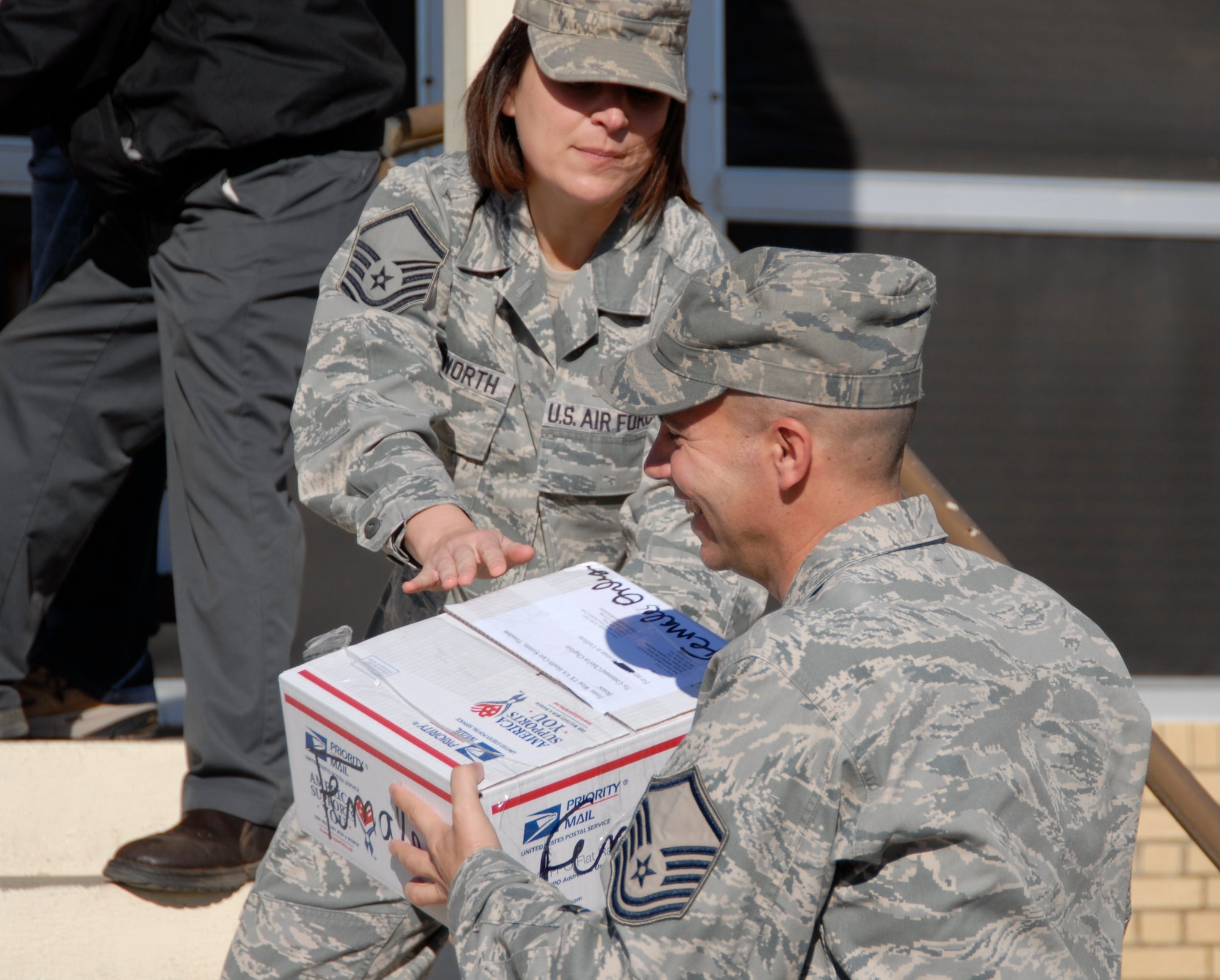 GOODFELLOW AIR FORCE BASE, Texas - Master Sgt. Kacy Ellsworth, 17th Training Wing Commander’s Action Group passes a care package to Master Sgt. Brandon O’Neil, 17th Force Support Squadron during the Operation Soldier Holiday program drive, Nov. 29 at the West Texas VA Medical Center, Big Spring, Texas. (U.S. Air Force photo/Airman 1st Class Anne Gathua)