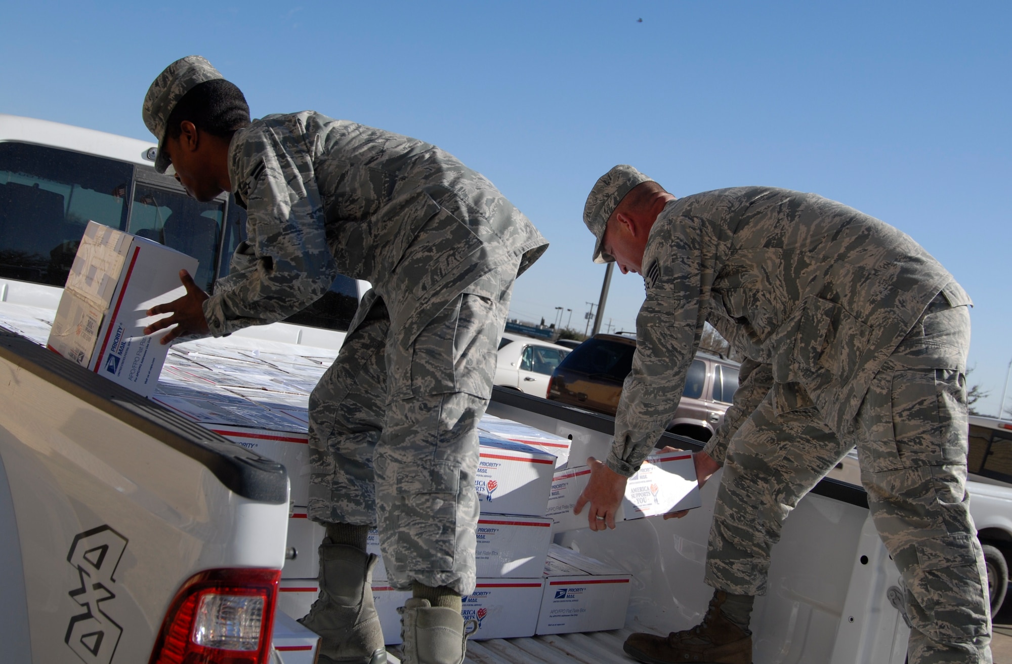 GOODFELLOW AIR FORCE BASE, Texas - Airman 1st Class Will Campbell, 17th Communications Squadron and Tech. Sgt. James Fountain, 17th Training Wing Safety, load care packages donated by West Texas VA Medical Center, Big Spring, Texas hospital staff, veterans and Big Spring and surrounding communities, Nov. 29. This was part of the Operation Soldier Holiday program. (U.S. Air Force photo/Airman 1st Class Anne Gathua)