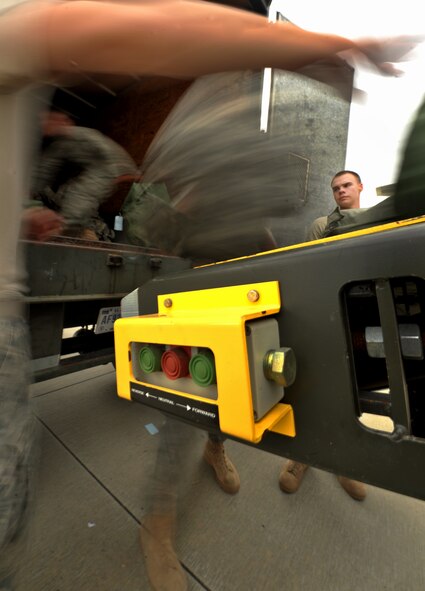 MOODY AIR FORCE BASE, Ga. -- Airmen from the 822nd and 824th Base Defense Squadron, load bags and equipment onto a Boeing 757 before departure of their fellow Airmen’s flight for a recent deployment. The 822nd and 824th BDS unloaded three trucks full of equipment and personnel items. (U.S. Air Force photo/Airman 1st Class Joshua Green)(RELEASED)

