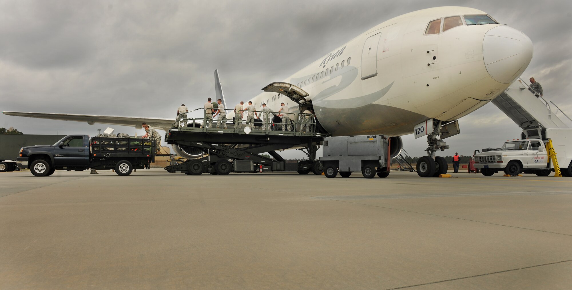 MOODY AIR FORCE BASE, Ga.-- Airmen from the 822nd and 824th Base Defense Squadron,  load bags and equipment onto a Boeing 757 before departure of their fellow Airmen’s flight for a recent deployment. The 824th BDS will be deploying to Southwest Asia for a tour of approximately six months. (U.S. Air Force photo/Airman 1st Class Joshua Green)(RELEASED)
