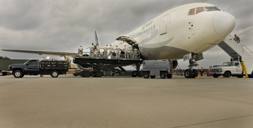 MOODY AIR FORCE BASE, Ga.-- Airmen from the 822nd and 824th Base Defense Squadron,  load bags and equipment onto a Boeing 757 before departure of their fellow Airmen’s flight for a recent deployment. The 824th BDS will be deploying to Southwest Asia for a tour of approximately six months. (U.S. Air Force photo/Airman 1st Class Joshua Green)(RELEASED)

