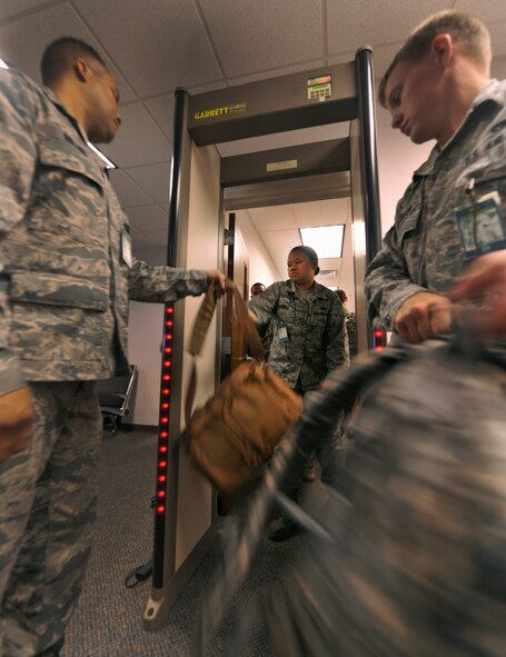 MOODY AIR FORCE BASE, Ga.-- Airmen from the 23rd Logistics Readiness Squadron pass bags through a metal detector during a deployment processing line for Airmen from the 824th Base Defense Squadron. Members from the 824th BDS were gearing up for a recent deployment that will last approximately six months. (U.S. Air Force photo/Airman 1st Class Joshua Green)(RELEASED)
