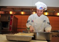 MINOT AIR FORCE BASE, N.D. -- Senior Airman Victoria Kemper, 5th Force Support Squadron dinner shift leader, prepares food for Airmen’s enjoyment at the Dakota Inn Dining Facility here Nov. 23. Airmen from the 5th FSS will provide support in preparing the holiday feast for the Day of Love, an annual event providing a home cooked meal to Team Minot’s elderly for the Thanksgiving holiday. (U.S. Air Force photo/Senior Airman Michael J. Veloz)