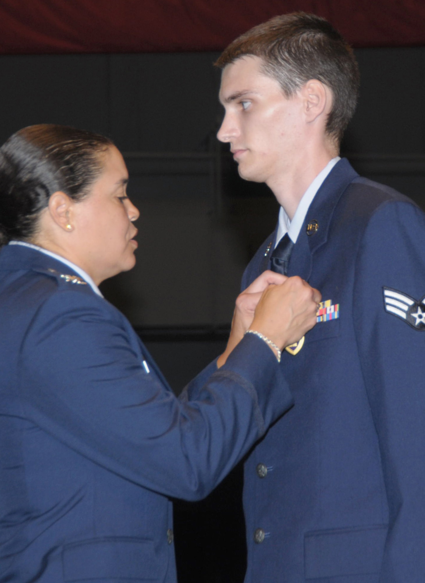 Col. Amanda Gladney pins a Purple Heart on the chest of Senior Airman Tre Porfirio July 8, 2010, at the National Museum of the U.S. Air Force in Dayton, Ohio, during the 15th Heroes Welcoming Heroes event. Airman Porfirio passed away Nov. 28, 2010, while visiting friends. Airman Porfirio was a voice network systems technician with the 88th Communication Squadron. Colonel Gladney is the 88th ABW commander. (U.S. Air Force photo/Al Bright)