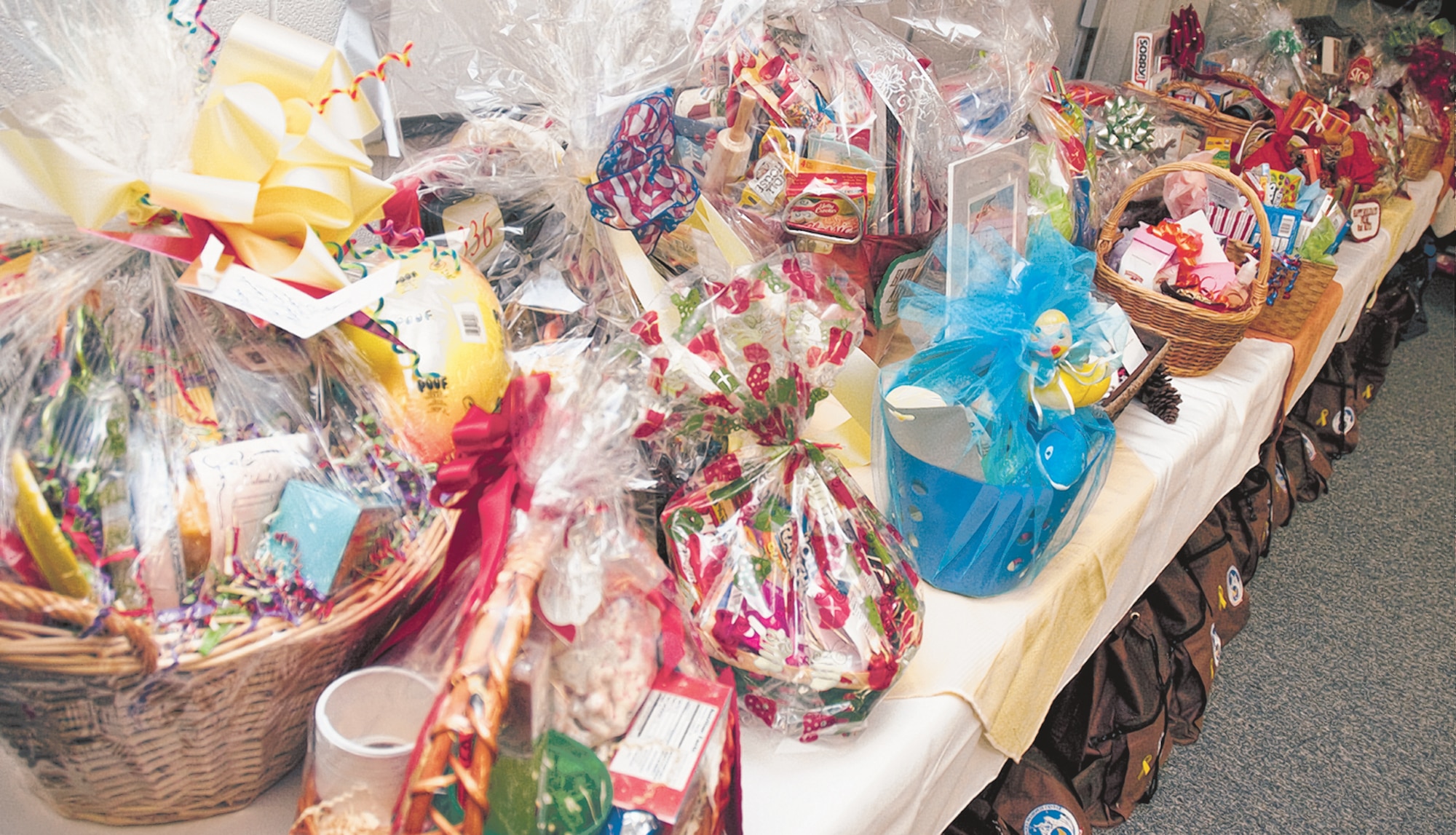 Gift baskets stuffed full of goodies were donated by every squadron on base as a way to thank the families of deployed Airmen for their support.  Following a traditional turkey dinner, children played games while their parents played Turkey Bingo for a chance to win a gift basket. (U.S. Air Force photo by Adam Bond)