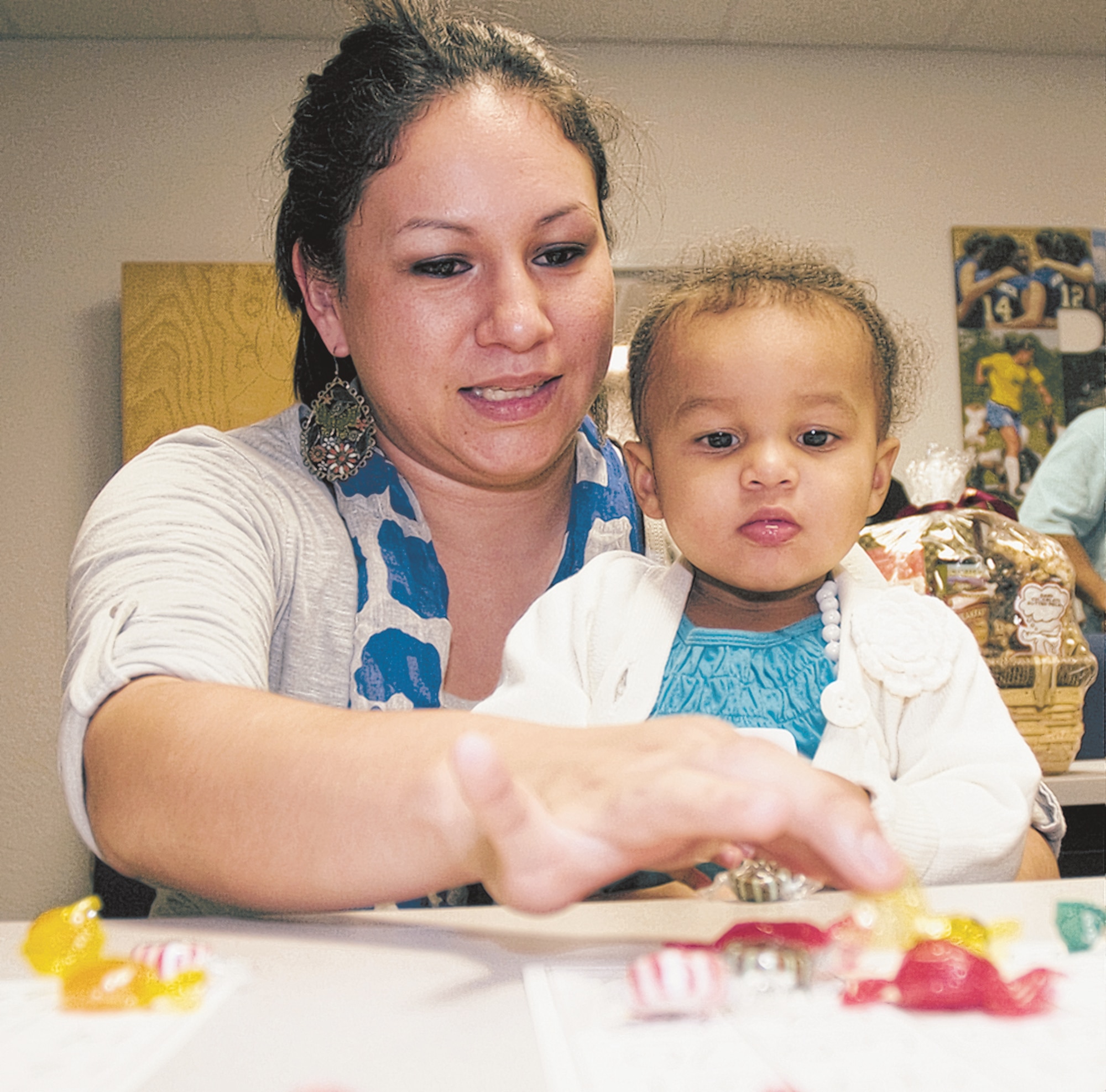Katherine Carruthers, wife of Staff Sgt. Terik Carruthers, 81st Medical Support Squadron, plays Turkey Bingo with her daughter Jennaya, 1½, during the airman and family readiness center’s Thanksgiving celebration for families of deployed members at the Sablich Center, Nov. 19. (U.S. Air Force photo by Adam Bond)