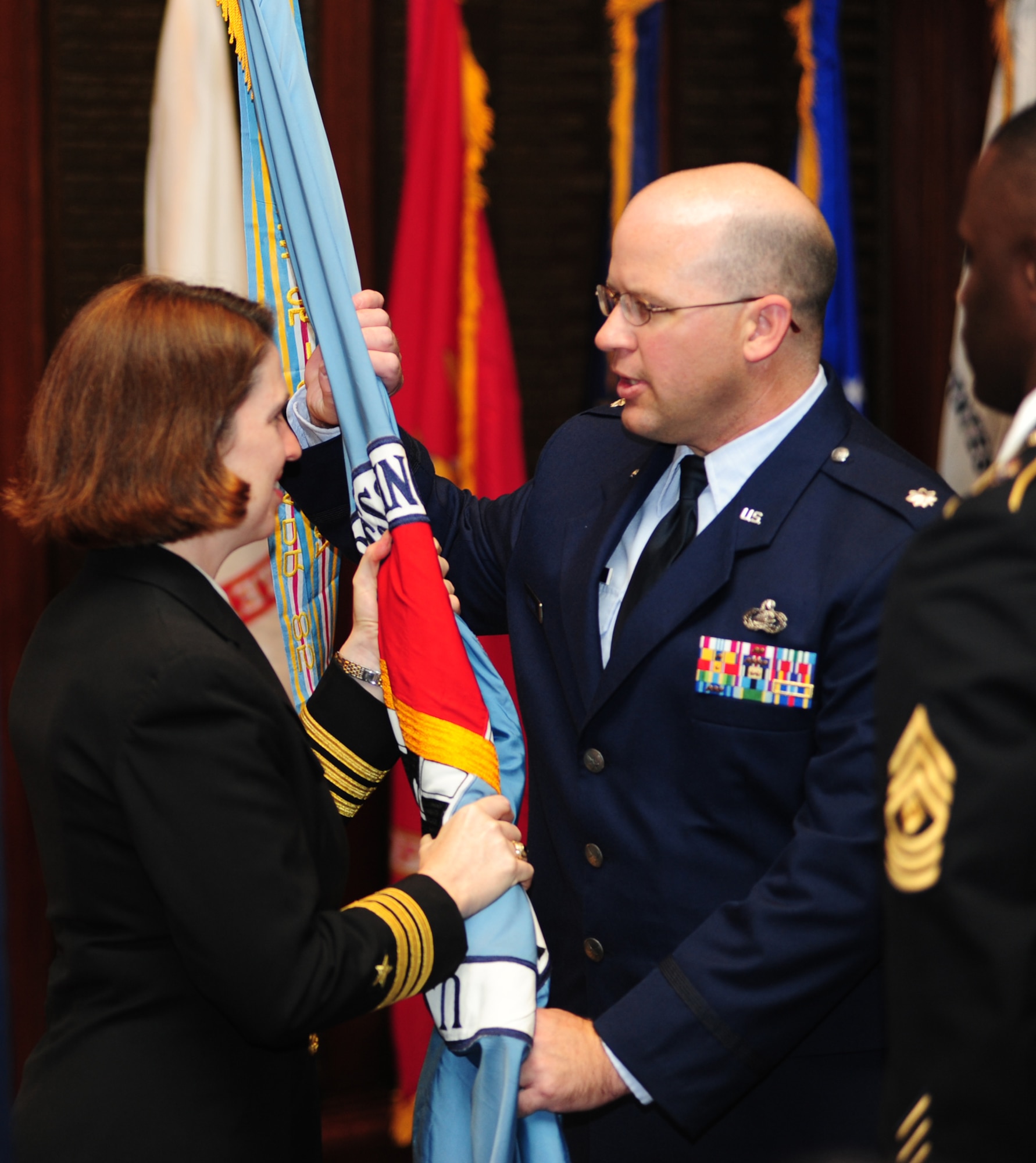 U.S. Air Force Lt. Col. Michael Goodwin, incoming commander of the Military Entrance Processing Station at Joint Base McGuire-Dix-Lakehurst, accepts the unit’s guide-on from U.S. Navy Commander Erin McAvoy, New York Entrance Processing Station commander representing 2nd Battalion, U.S. Military Entrance Processing Command, Nov 23. in Philadelphia. Col. Goodwin takes over from the outgoing commander, U.S. Air Force Maj. Jerry Brooks, who goes on to an assignment in the Kingdom of Saudi Arabia. (U.S. Air Force photo/Staff Sgt. Zachary Wilson)