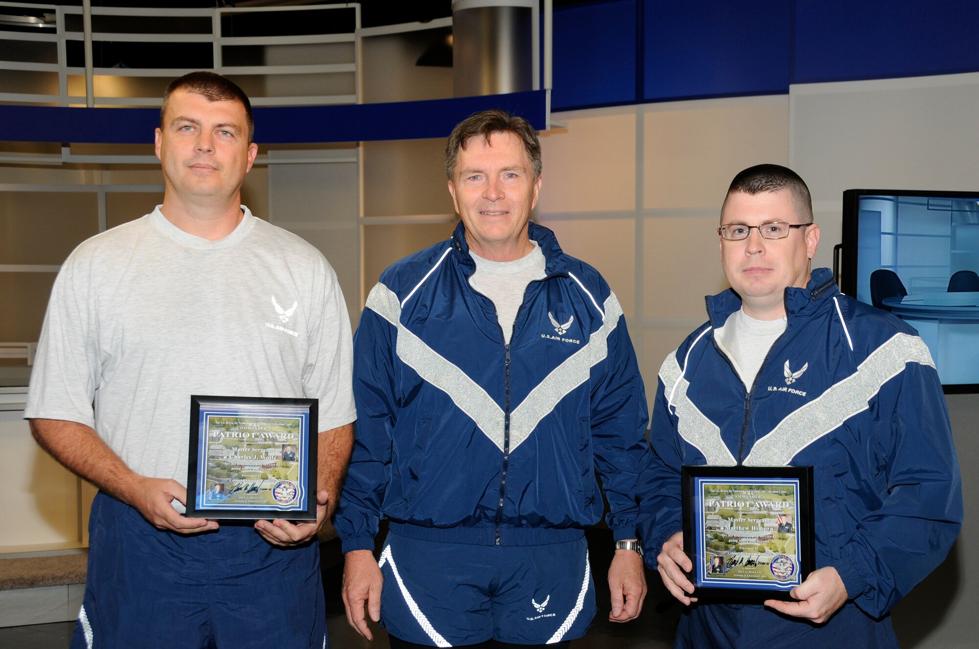 McGHEE TYSON AIR NATIONAL GUARD BASE, Tenn. - Col. Richard B. Howard, center, commander of The I.G. Brown Air National Guard Training and Education Center here, presents his Patriot Award to Master Sgt. Jason Wolfe, left, NCOIC of infrastructure management for the communications focal point section, and Master Sgt. Matt Hilborn, right, broadcast manager for the TEC-TV studios, for recognition of their contributions to the center, Nov. 24, 2010. The Patriot Award is Howard's personal award to show appreciation for those he feels have gone above and beyond in their service. (U.S. Air Force photo by Master Sgt. Kurt Skoglund/Released)