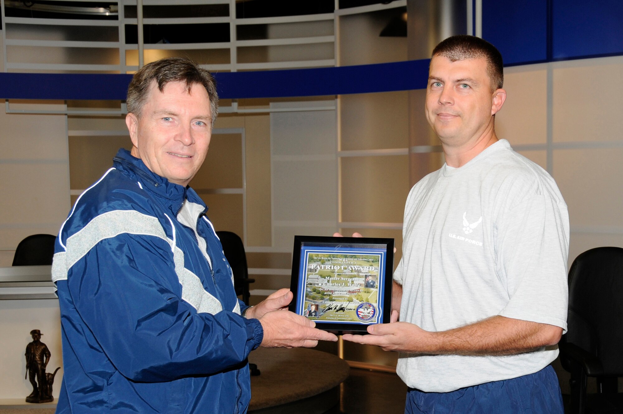 McGHEE TYSON AIR NATIONAL GUARD BASE, Tenn. - Col. Richard B. Howard, left, commander of The I.G. Brown Air National Guard Training and Education Center here, presents his Patriot Award to Master Sgt. Jason Wolfe, right, NCOIC of infrastructure management for the communications focal point section, for recognition of his contributions to the center, Nov. 24, 2010. The Patriot Award is Howard's personal award to show appreciation for those he feels have gone above and beyond in their service. (U.S. Air Force photo by Master Sgt. Kurt Skoglund/Released)