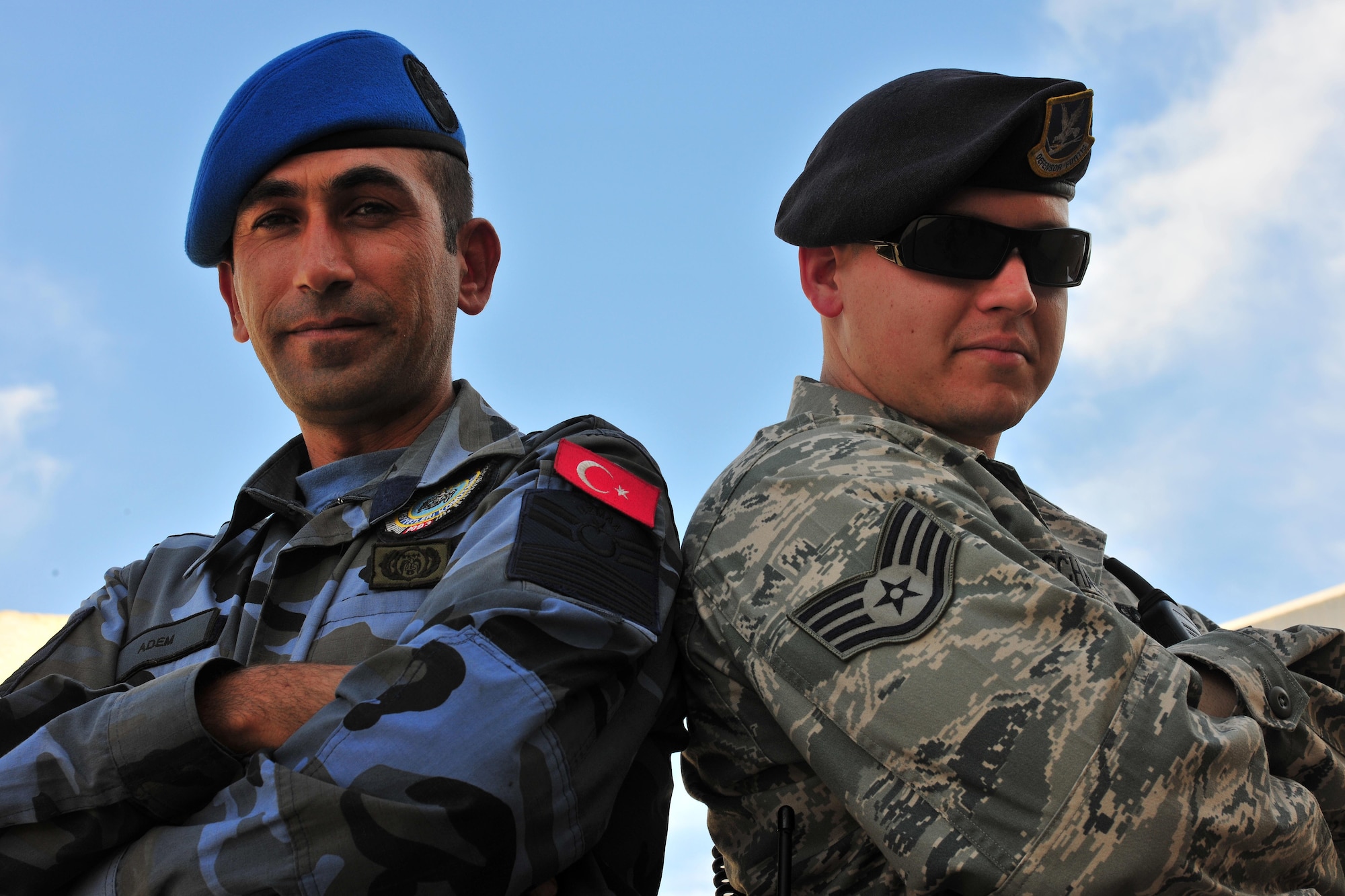 Airman Adem (left), Turkish Air Force Security Forces patrolman, and Staff Sgt. Ryan Schaefer (right), Security Forces Squadron patrolman, work as a team during a joint patrol Oct. 22, 2010 at Incirlik Air Base, Turkey.  Patrolmen are in charge of performing random security checks on assigned buildings, responding to emergency calls and safeguarding the base.  (U.S. Air Force photo by Senior Airman Ashley Wood/Released)