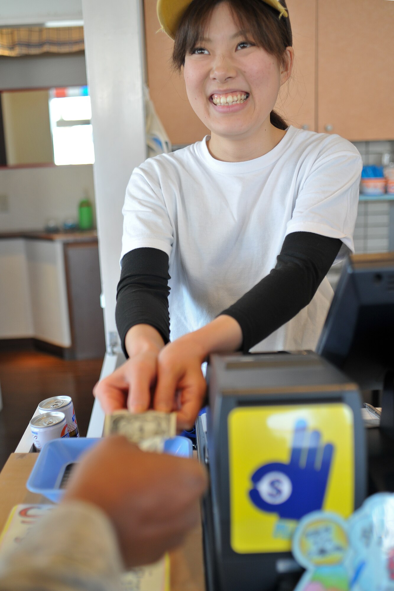 FUSSA, Japan -- Senior Master Sgt. Valarry Smith, Armed Forces Network Tokyo, makes a purchase in a Japanese business using American dollars. When you go shopping on Route 16, you can use U.S. dollars for payment, if you see a "Dollar OK" sticker in front of the store. (U.S. Air Force photo/Osakabe Yasuo)
