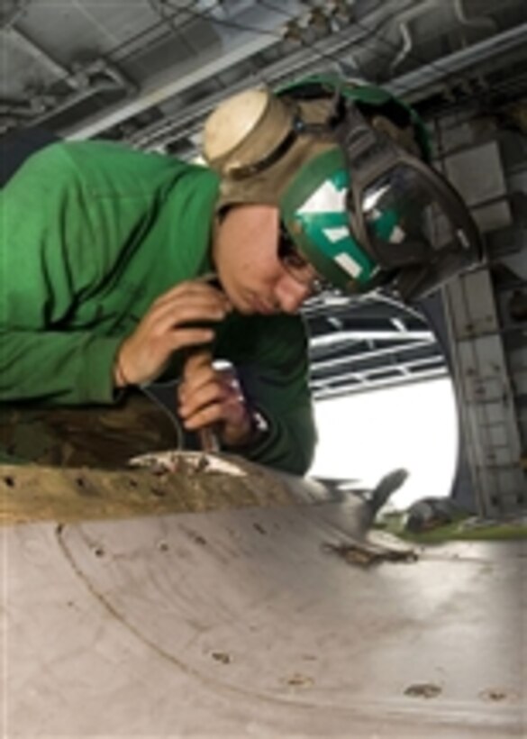 Petty Officer 3rd Class Luke Spataro performs corrosion control on an F/A-18E Super Hornet aboard the aircraft carrier USS George Washington (CVN 73) in the Pacific Ocean on Nov. 26, 2010.  The George Washington is on patrol in the western Pacific Ocean helping to ensure security and stability.  