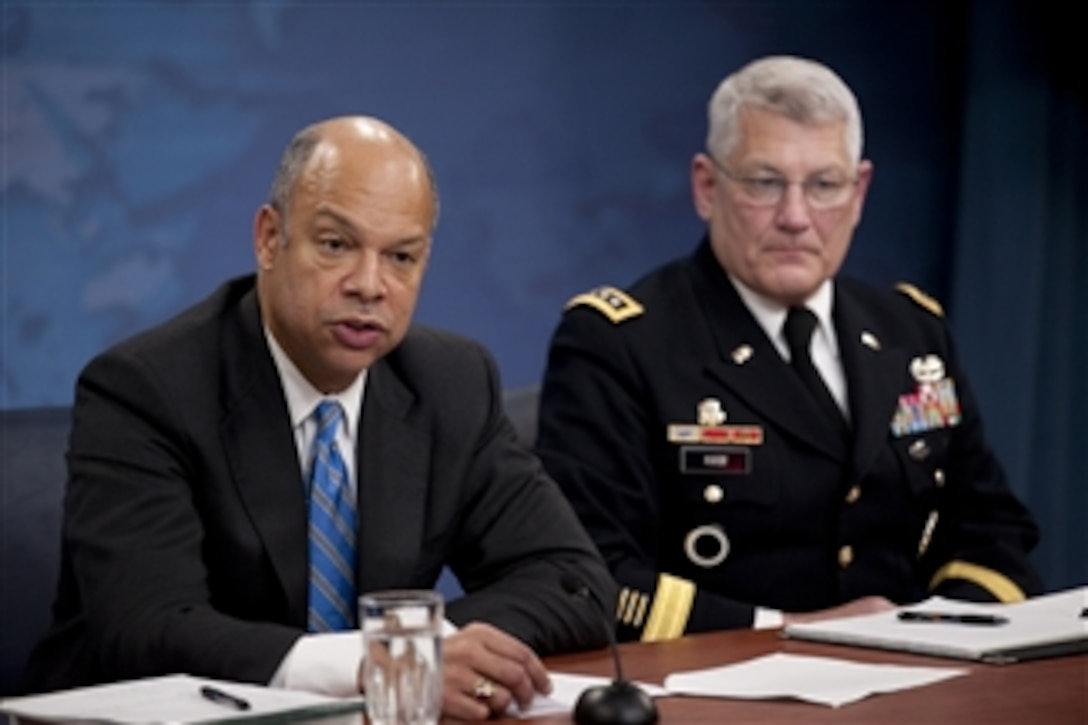 Department of Defense General Counsel Jeh C. Johnson and U.S. Army Gen. Carter Ham conduct a press briefing in the Pentagon discussing the public release of the "Don't Ask, Don't Tell" Comprehensive Working Group report on Nov. 30, 2010.  