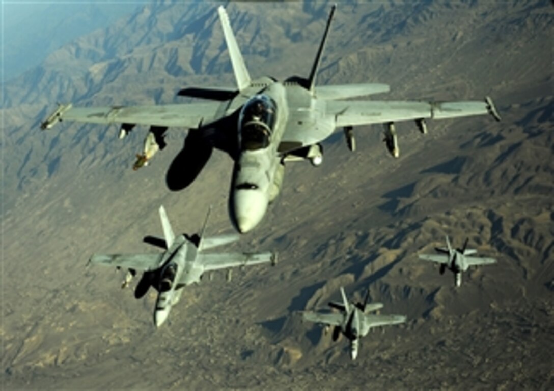 Four U.S. Navy F/A-18 Hornet aircraft fly over mountains in Afghanistan on Nov. 25, 2010.  