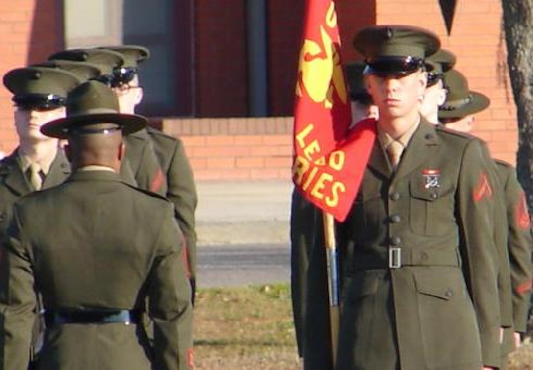 Newly minted Pfc. Matt McGuiness holds the battalion guidon during his recruit training graduation ceremony Jan. 15. McGuiness endured painful surgeries and a long recovery after being medically discharged from Marine Corps recruit training a year earlier due to lung problems.