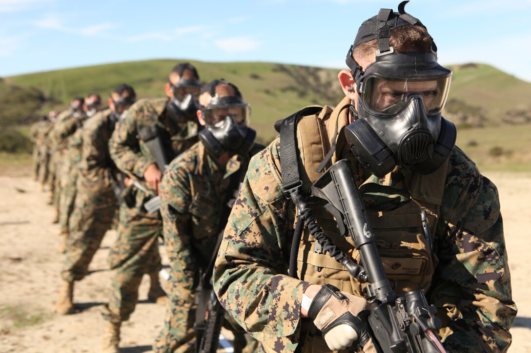 Cpl. Adam J. Rigdon, the 11th Marine Expeditionary Unit armory chief, participates in combat marksmanship training with the  M-50 field protective mask here Nov. 30.
