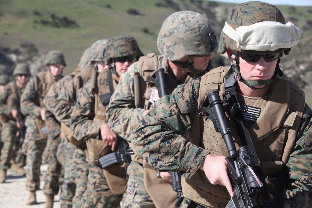 Marines with the 11th Marine Expeditionary Unit prepare to pivot and shoot during Table 3 marksmanship training here Nov. 30. The MEU is conducting annual training as a command element in preparation for an upcoming deployment.