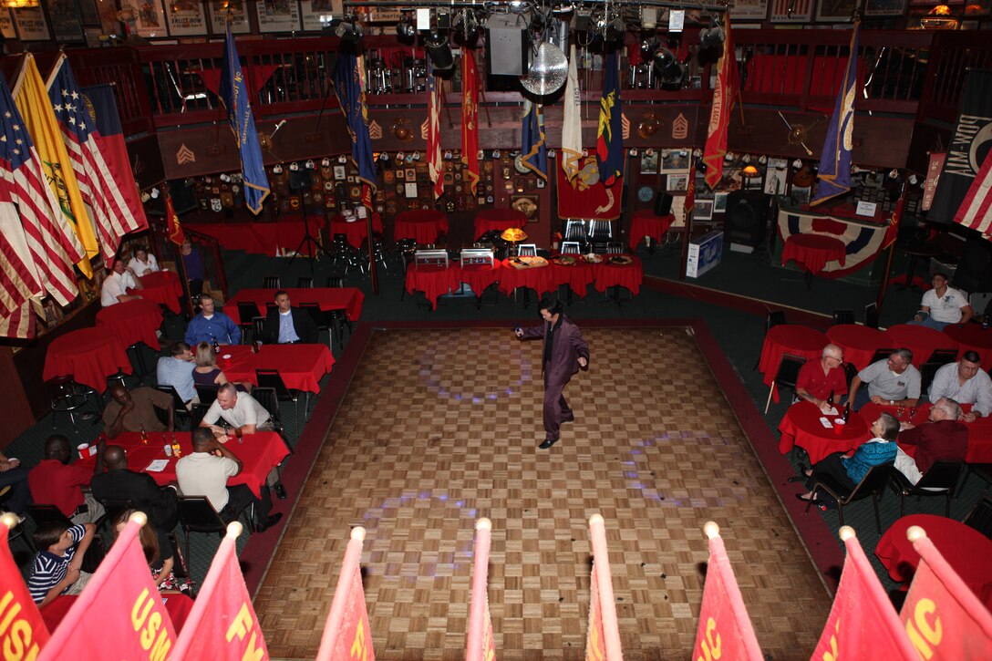 Jay Barnes (center), an entertainer with St. Charles Productions, dances for the crowd during the Big Dog Reception at Sywanyks Scarlet and Gold Traditions, located in Jacksonville, N.C., Oct. 1.  The event was open to all staff noncommissioned officers – both past and present – from any branch of military service.