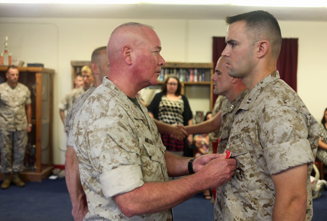 Kalmar operator Jeff Layfield demonstrates how emptied containers of military equipment returned from Iraq were stacked as ground guide Randy Curles assists him. The Marine Corps Logistics Command team emptied the last container Sept. 20.