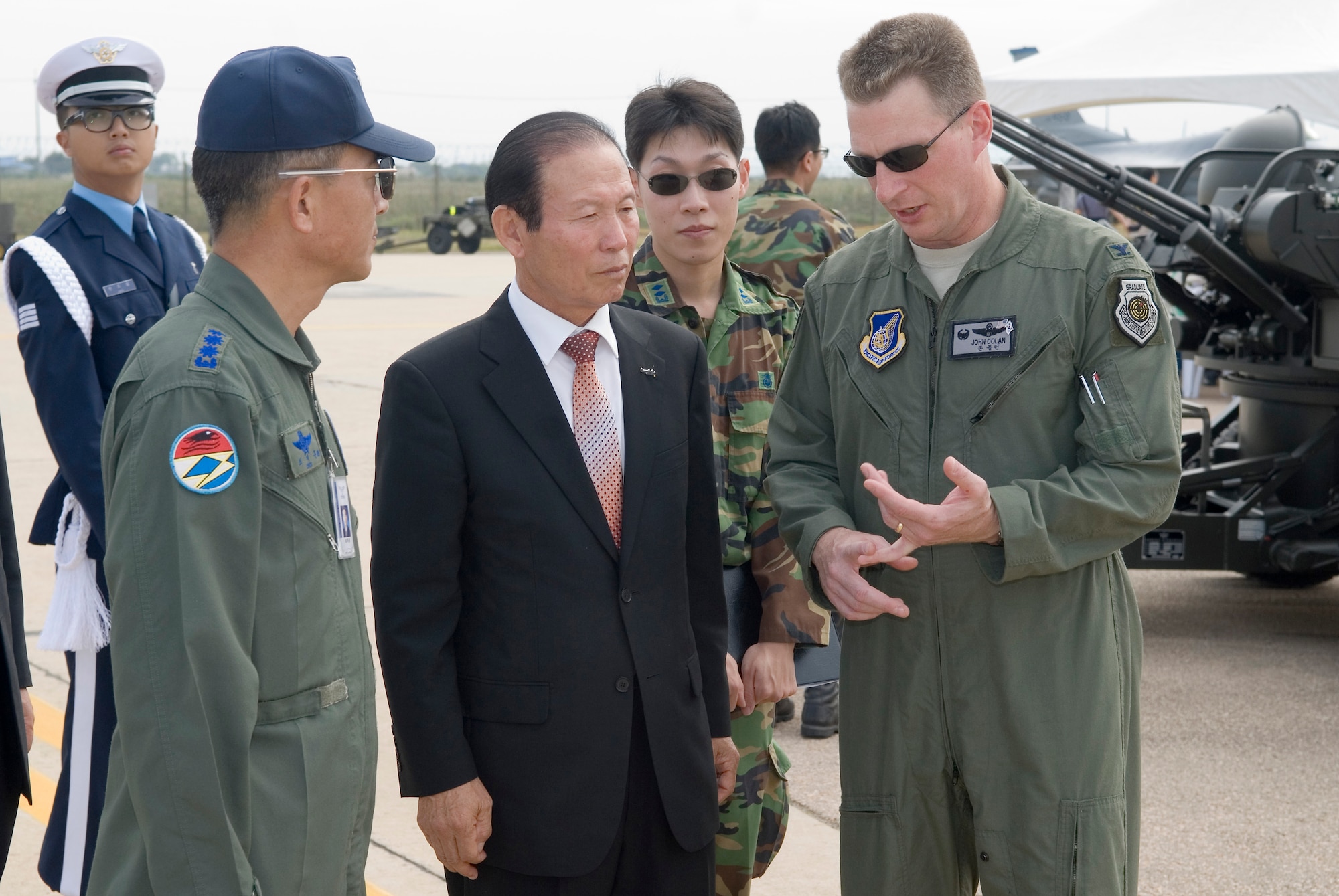KUNSAN AIR BASE, Republic of Korea -- Col. John Dolan (right), 8th Fighter Wing commander, and Col. Choi Jae-Hun (left), Republic of Korea Air Force 38th Fighter Group commander, speak with Gunsan City Mayor Moon Dong-Shin during the Kunsan Air Base Open House and Gunsan Appreciation Day here Oct. 1, 2010. The base opened its doors to the local community and held events including an F-16 Fighting Falcon fly-by, Korean dance performances, static displays, organizational booths, military working dog demonstrations, aircraft munitions-loading competitions, music and more. (U.S. Air Force photo/Senior Airman Ciara Wymbs)