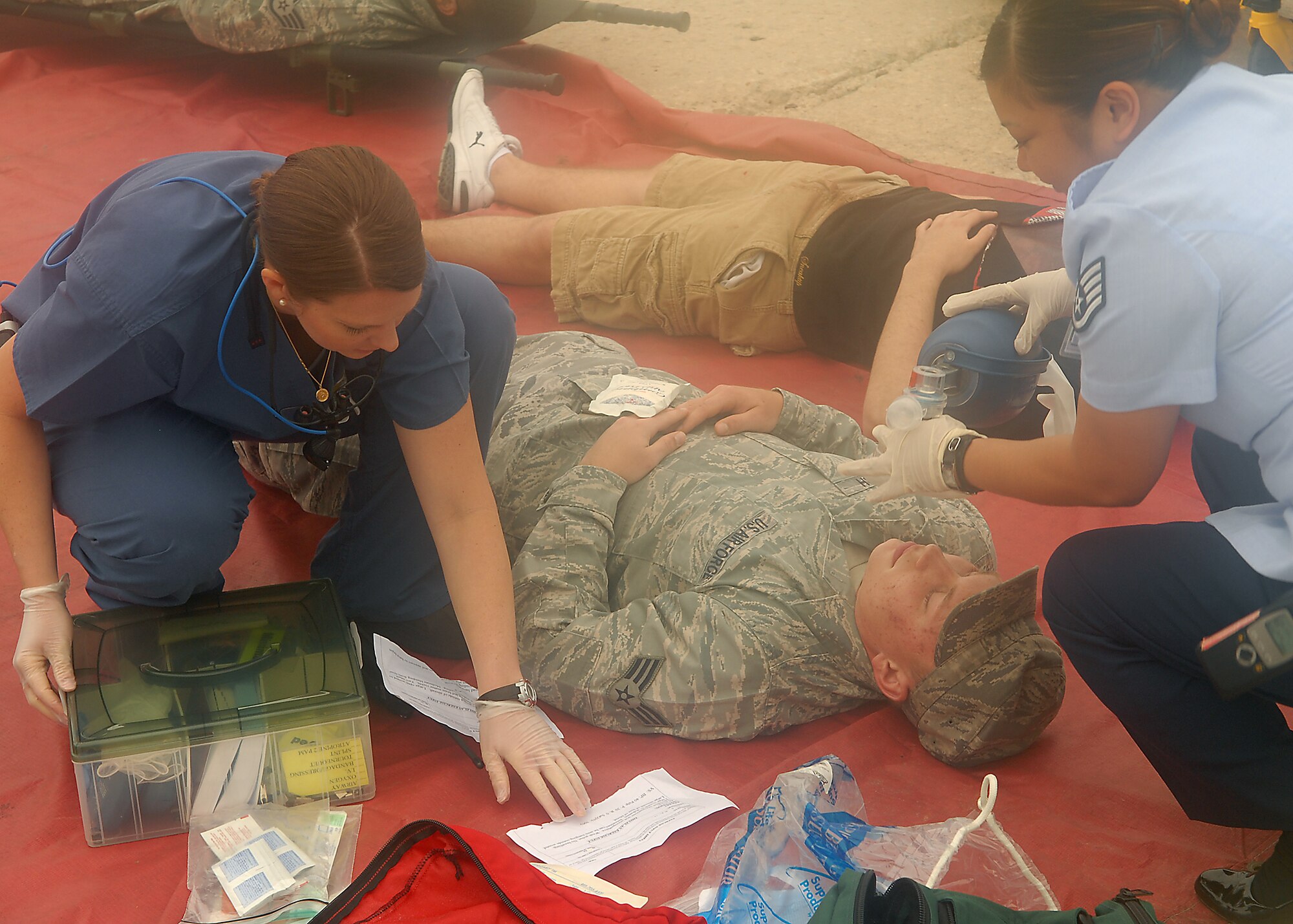 KUNSAN AIR BASE, Republic of Korea -- Staff Sgt. Pauline Hoyla (right), 8th Medical Group, works to establish an open airway on a crash victim from a simulated plane crash during exercise Beverly Hotel 10-6 here Sept. 27, 2010. During the exercise Airmen worked together to get all the victims to safety, extinguish the burning aircraft, and practiced self-aid and buddy care. (U.S. Air Force photo/Senior Airman Ciara Wymbs) 