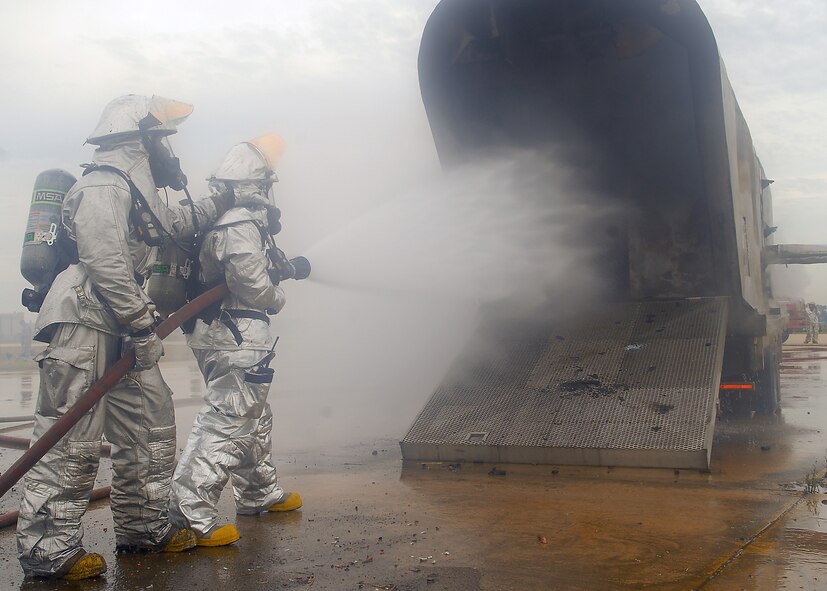 KUNSAN AIR BASE, Republic of Korea -- Senior Airman Maurice Fulton and Tech. Sgt. Felsia Jones, 8th Civil Engineer Squadron firefighters, work to extinguish a simulated burning aircraft during exercise Beverly Hotel 10-6 here Sept. 27, 2010.  During the exercise Airmen worked together to get all the victims to safety, extinguish the burning aircraft, and practiced self-aid and buddy care. (U.S. Air Force photo/Senior Airman Ciara Wymbs) 