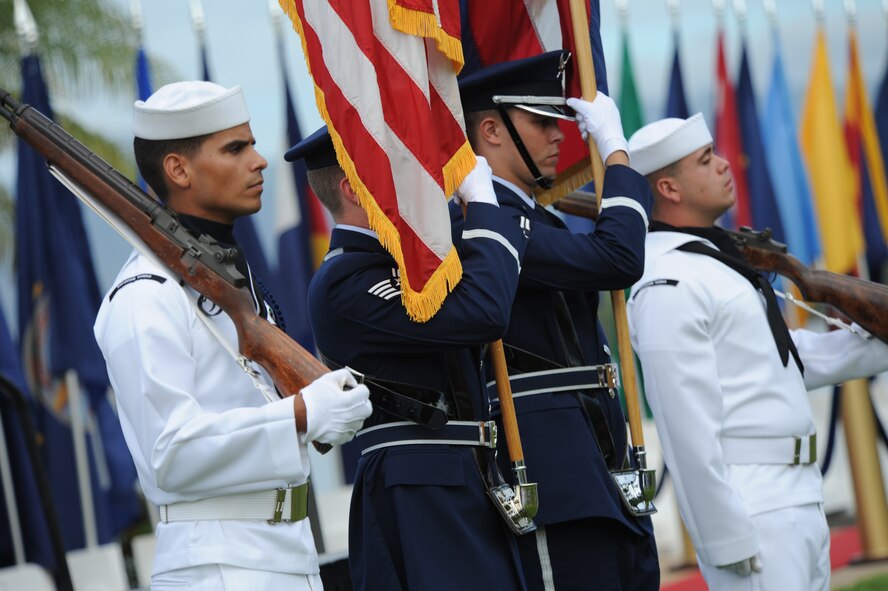 Navy and Air Force honor guard members present the colors for the Full Operational Capability Commemoration Ceremony Oct. 1 at the Missing Man Formation Memorial at Aloha Aina Park. The FOC ceremony marks the joining of two historic military installations, Naval Station Pearl Harbor and Hickam Air Force Base. (U.S. Air Force photo by Staff Sgt. Nathan Allen)

